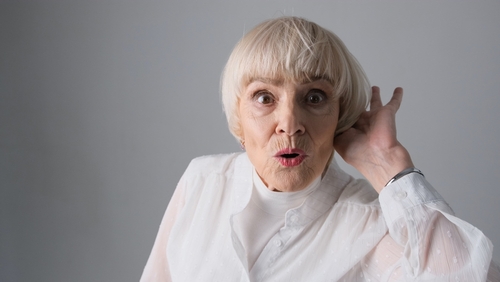 Mature woman holding her ear