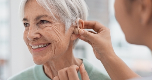 Mature woman getting fitted for a hearing aid